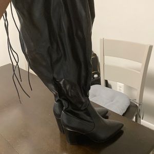 Block heel thigh high boots with elastic wide calf.